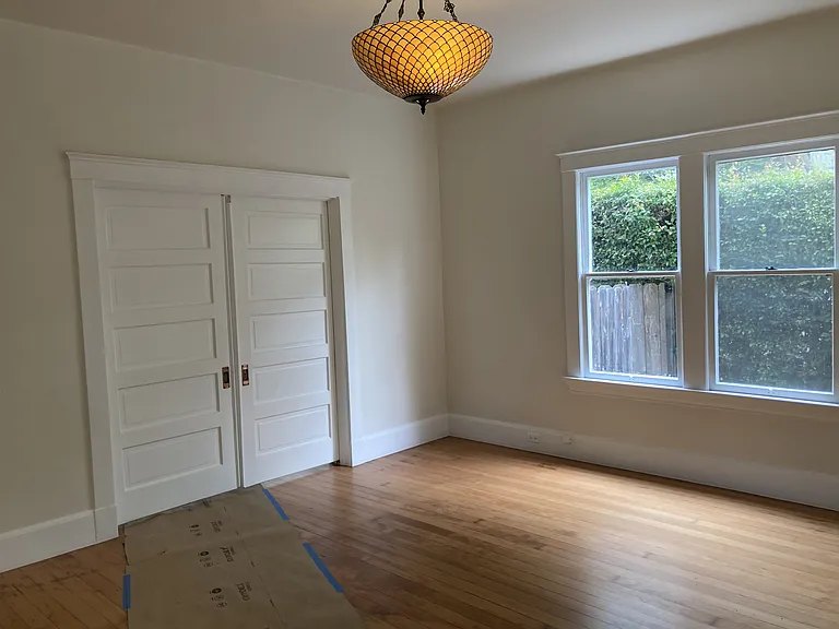Original communicating doors between the living and dining rooms with the original copper handles