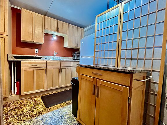 Kitchen area, showing granite top island.