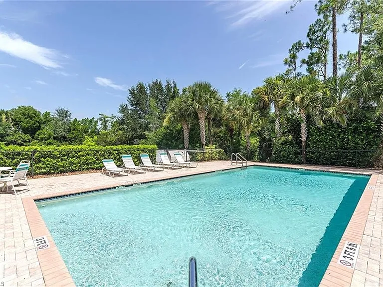 Enjoy a refreshing dip in the quiet second pool, surrounded by lush palm trees and tropical greenery. This smaller, more private pool area is perfect for relaxing afternoons in the sun, reading a book under the umbrella, or barbequing.