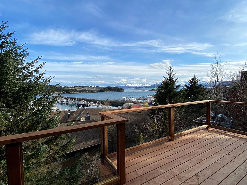 Kitchen and living room deck with views of city, mountains and harbor, sunsets and sunrises.