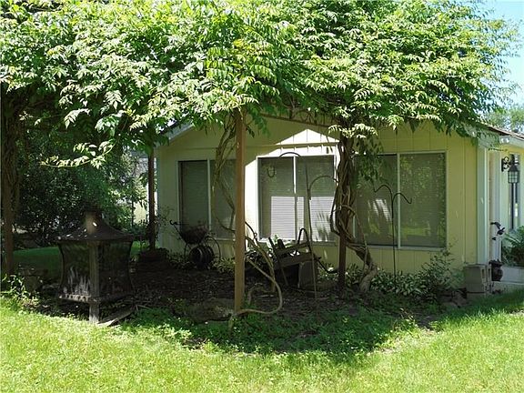 ENTERTAIN GUESTS ON PATIO UNDER THE SHADE.