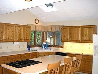 Large, vaulted, eat-in kitchen with skylights and breakfast bar island