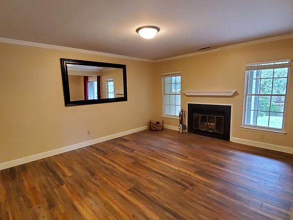 Spacious and gracious living room. Mirror stays unless you don't want it.