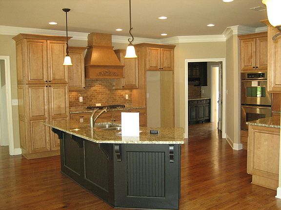 Completely remodeled kithcen with custom maple cabinetry, granite, an island