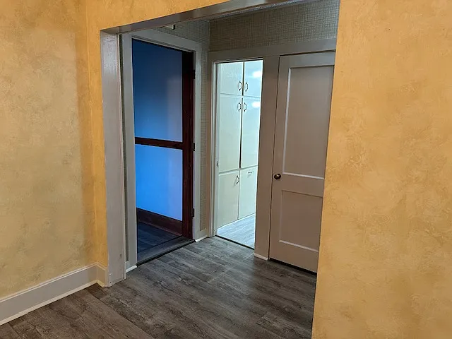 dining room looking toward hallway with living room on left and bathroom and hall closet