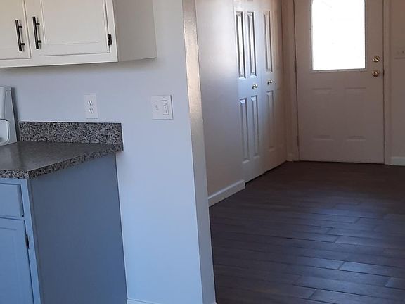 Kitchen, living room, front entrance.