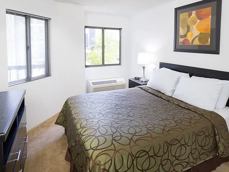 Bedroom with queen bed and dresser