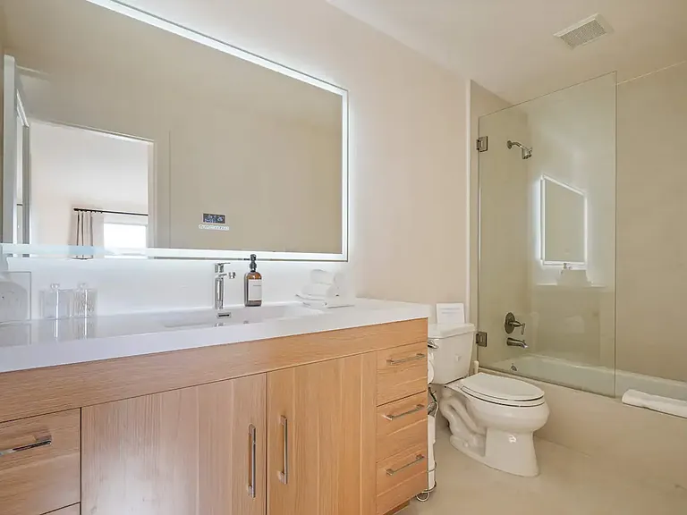 Spacious and modern bathroom with a walk-in shower and plenty of light.