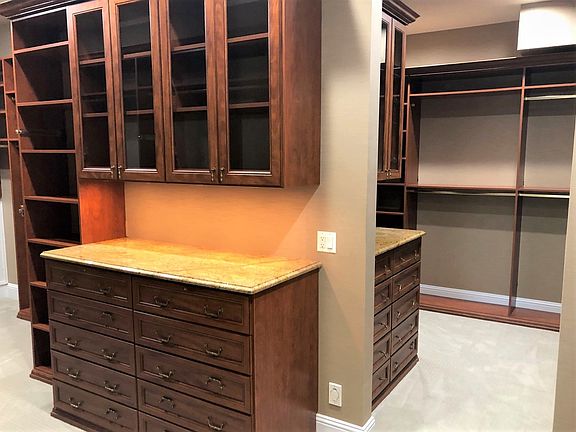 This sumptuous walk in closet (10 x 20) is completely compartmentalized for the homeowners needs. Ex