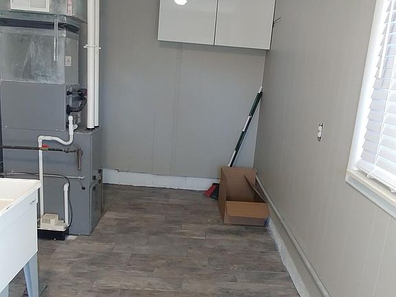 Shared utility room includes washer, dryer and furnace.