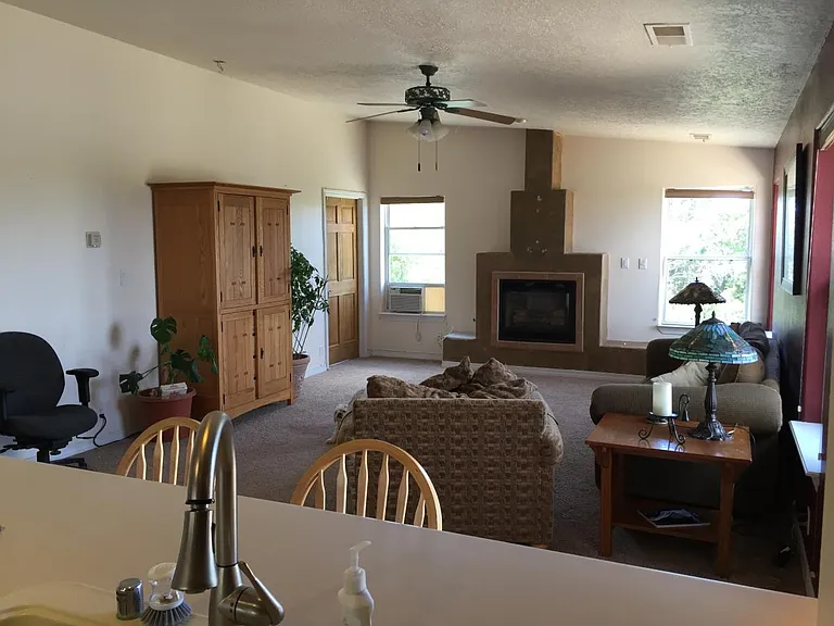 Kitchen sink/counter looking into family room & door to primary bedroom with large on suite bathroom.