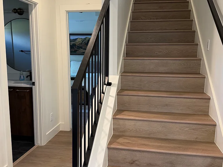 To the left is the lower level queen bedroom and full bath; stairs up to main level