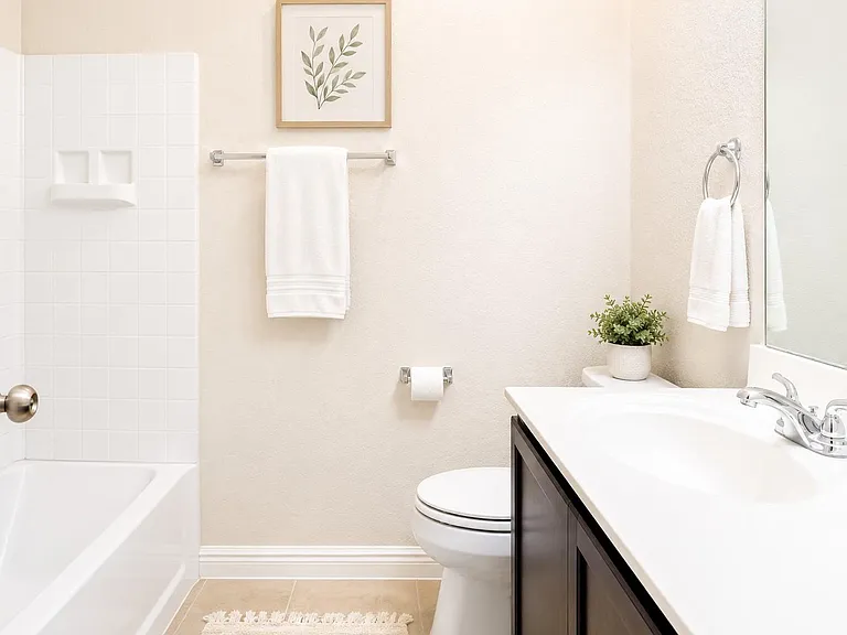Well-appointed full bath with tub/shower combo, large vanity with ample counter space, and wall mirror for daily routines.