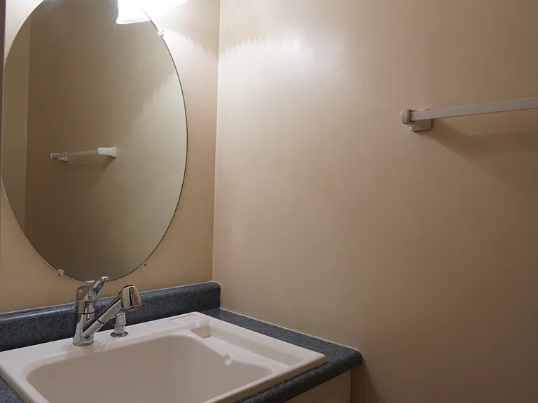 Half bath in basement, large utility sink.