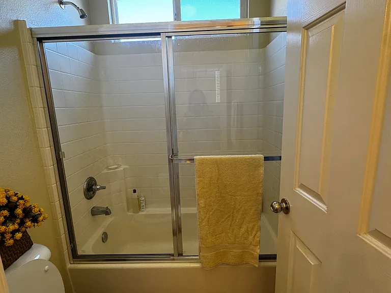 Shared bathroom shower tub and toilet area
