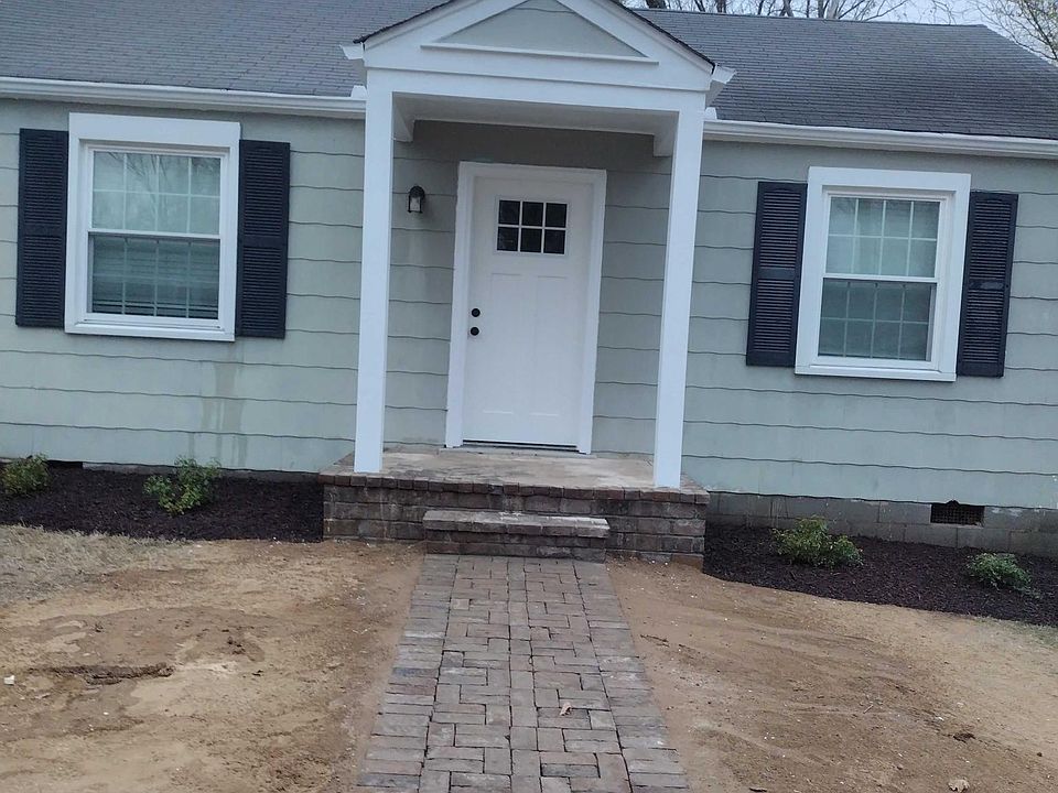 Just finished adding a new porch, entry path and landscaping! Now we just need the grass to grow in this mild December weather!