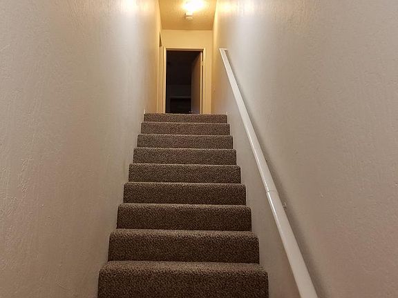 Stairs up to the two bedrooms.