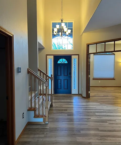 The entryway from the kitchen dining area. Office at right, laundry room door and stairs at left.