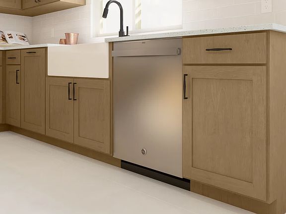 White apron-front sink and stainless steel appliances