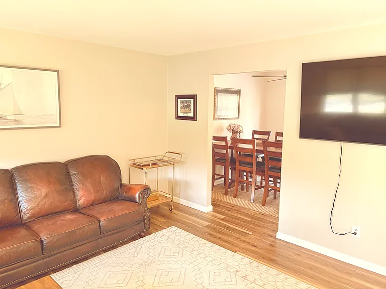 Living room seamlessly connects to the dining room and kitchen through a semi_open layout