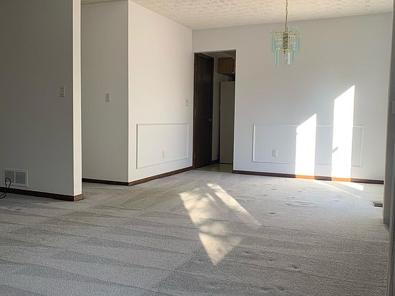 Living room open to dining area - french doors look out onto the back yard
