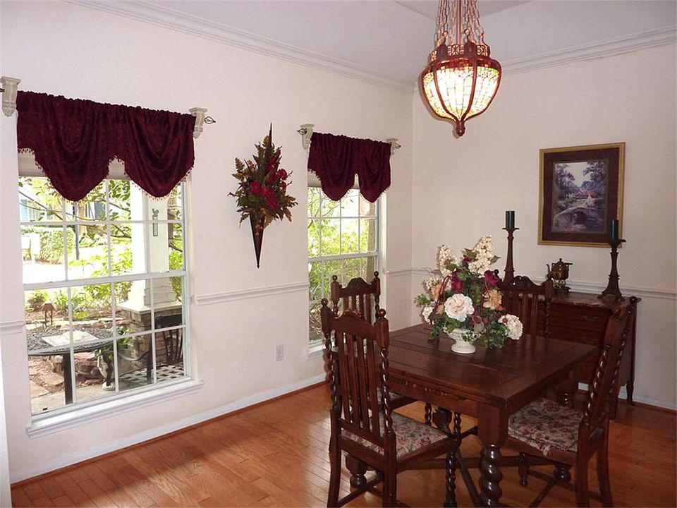 Formal Dining Room with Wood Floors , Crown and Chair Rail Moulding.