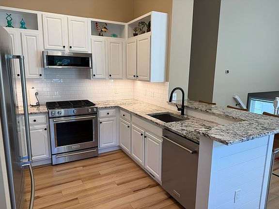 Newly remodeled kitchen with granite counters and stainless steel Kitchen Aid appliances.