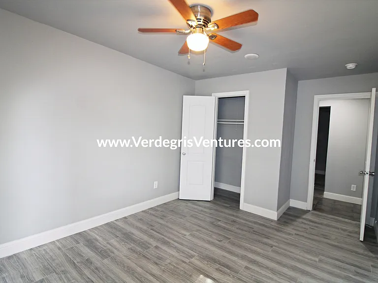 Bedroom 3: guest bedroom offers abundant natural light, a comfortable closet, and a ceiling fan.