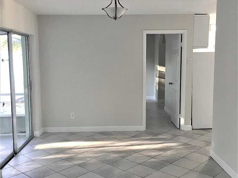 Dining Room/ Florida Room
4 sliding glass doors into the Patio to the left.
Door leading to Master Bedroom