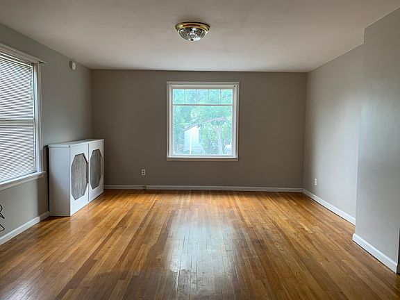 Living room. Views to the South and East. Hardwood floors. Hot water heat. Entrance from stairway is to the right.