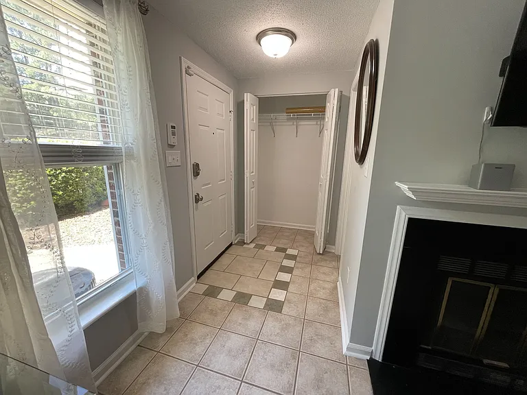 Front entrance with good size coat closet, electronic door lock, and security system keypad