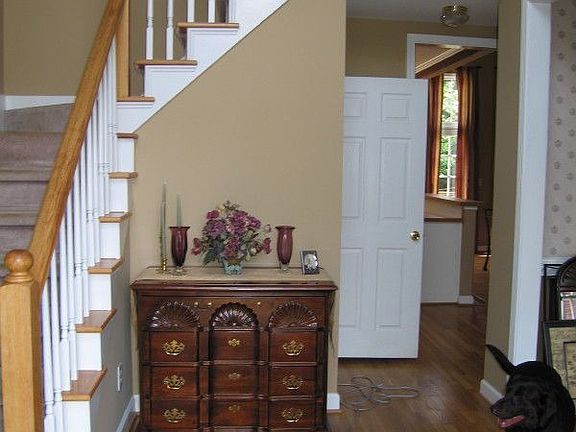 Entryway with refinished hardwood floors and new paint
