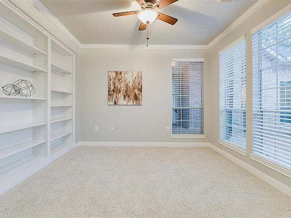 Imagine working from this Home Office with a wall of windows on one side and Floor to Ceiling Shelving on the other side. The generous space affords you the flexibility you'll love to use the furniture of your choice. Hunter Douglas Blinds are attrac