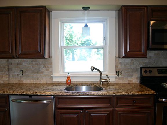 Stainless steel appliances, granite and well stocked kitchen which includes dishes, glasses, silverware, glasses, etc.