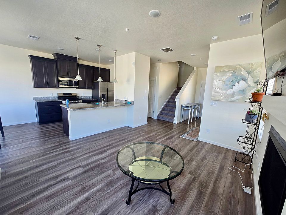 The main floor offers a convenient half bath, laundry room, storage space, and direct access to the attached garage.