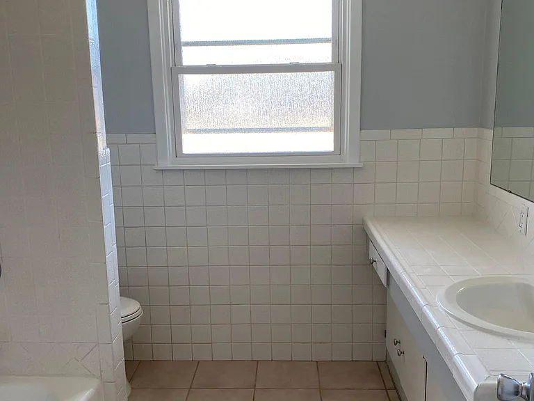 Primary restroom for the house. New paint and newly resurfaced bathtub.