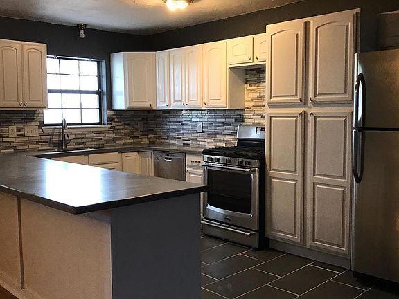 Kitchen with solid surface counter tops, stainless appliance