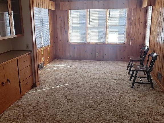 Dining room with a view into a potential 3rd bedroom or den