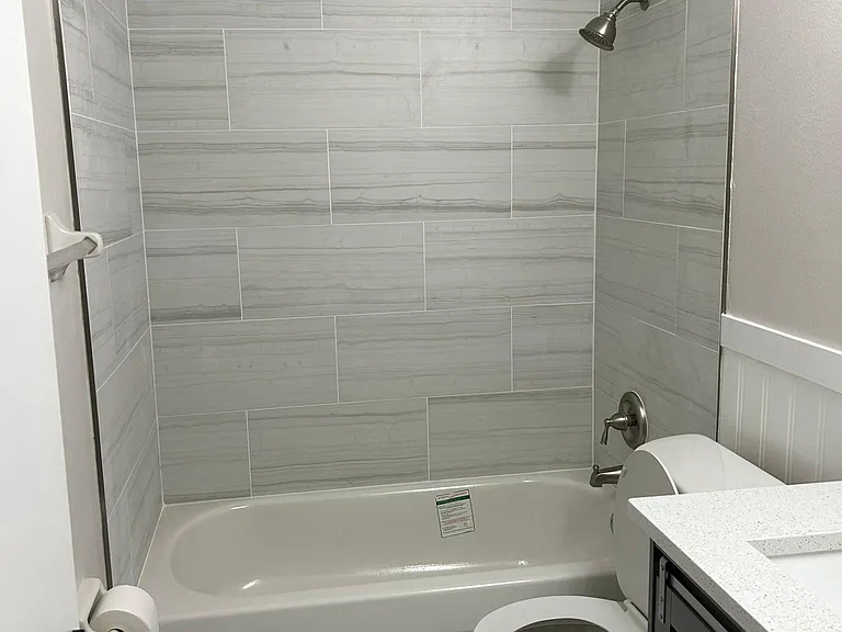 Completely Remodeled Upstairs Bathroom with Brand New Tub, Tile, Shower Fixtures and Tile Flooring