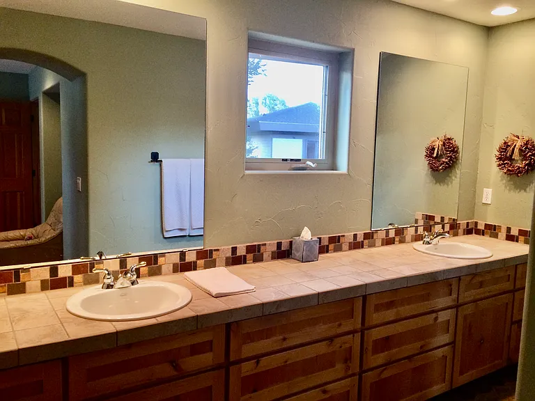 Primary bedroom with duel sinks and plenty of cabinet storage.