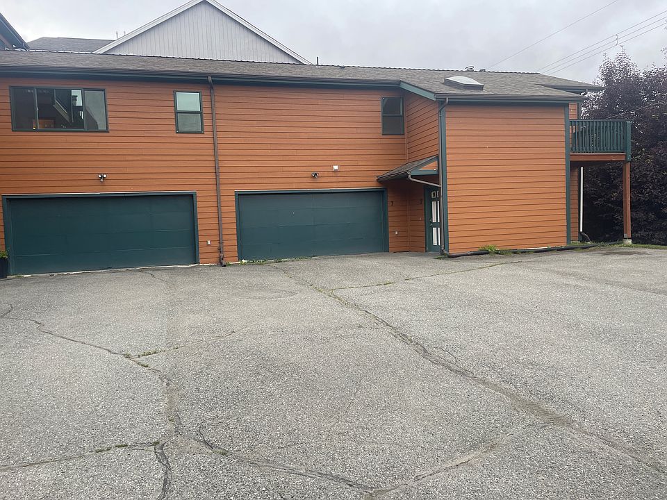 The condo is on the far right. Garage, front door, balcony on the corner. Three designated parking spaces in the lot, as well as a two-car garage, and space in front of the garage.