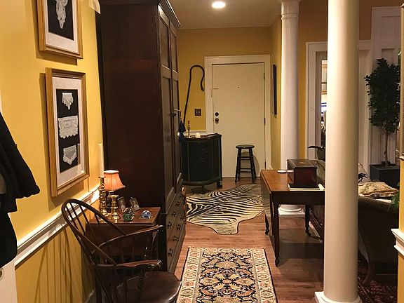 Standing with back to front door looking toward living room at right; one of two kitchen access/entries is immediately to the right outside of camera view