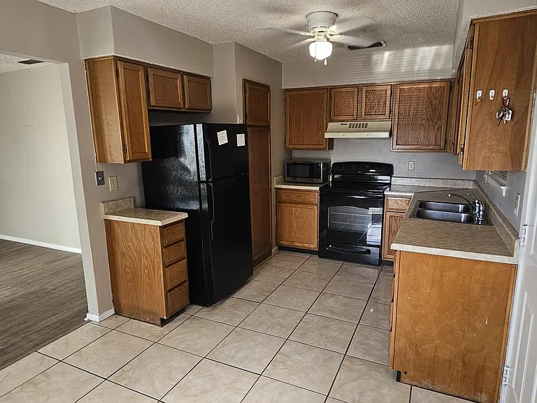 Home comes with refrigerator, stove, & microwave. Dining room next to kitchen.