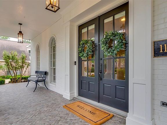 Graceful entry includes herringbone brick porch