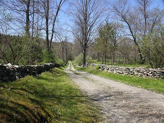 Century old stonewalls lead you far from the road to the home.