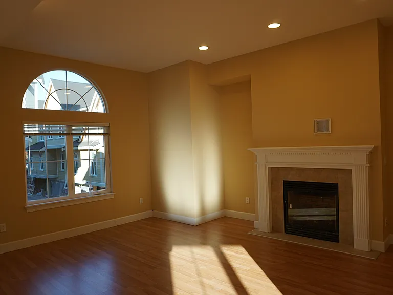large living room with cozy gas fire place .