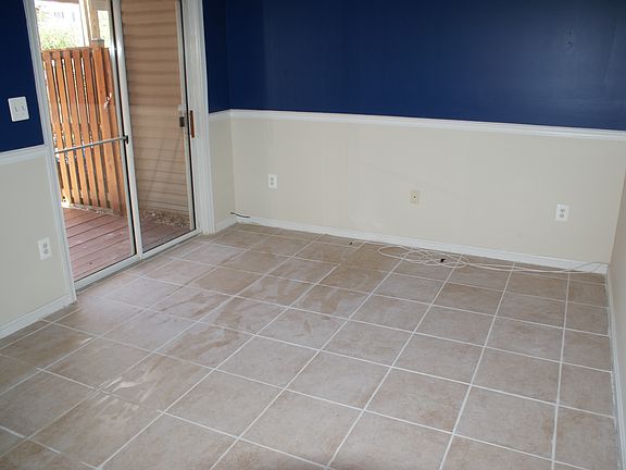 Basement walk-out to backyard and community area with tile.