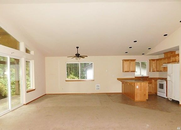 Living room that is open to eating space and kitchen.  Slider to the front deck.