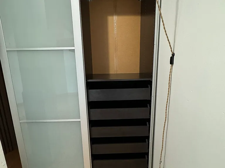 5 pull out drawers, hanging space above. Lighting above to see what to wear