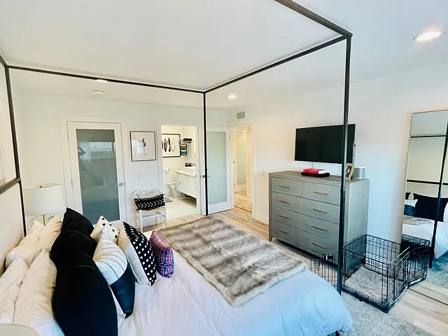 Large bedroom looking towards en suite bathroom and walk-in closet